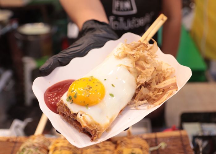 A portion of hashimaki (okonomiyaki on chopsticks) served a food stall