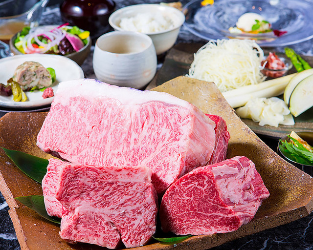Gourmet steak course with assorted sides and salad