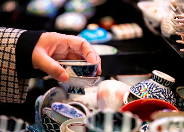 Somebody shopping for tableware in a Kyoto flea market.
