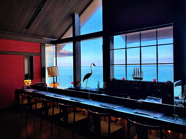 Seaside restaurant interior with ocean view and elegant decor