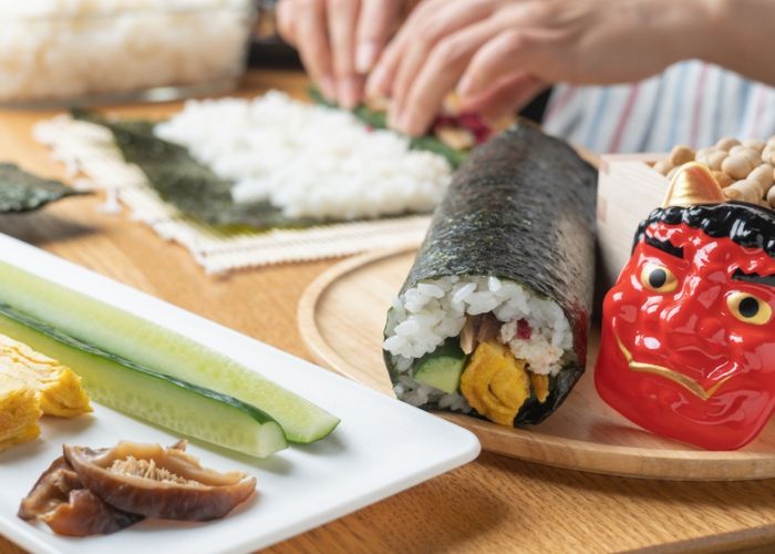 A woman makes ehomaki, a traditional Japanese food eaten during Setsubun