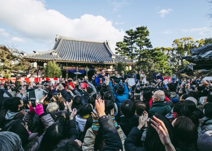 A crowd of people attending the Setsubun celebrations at a temple in Kyoto