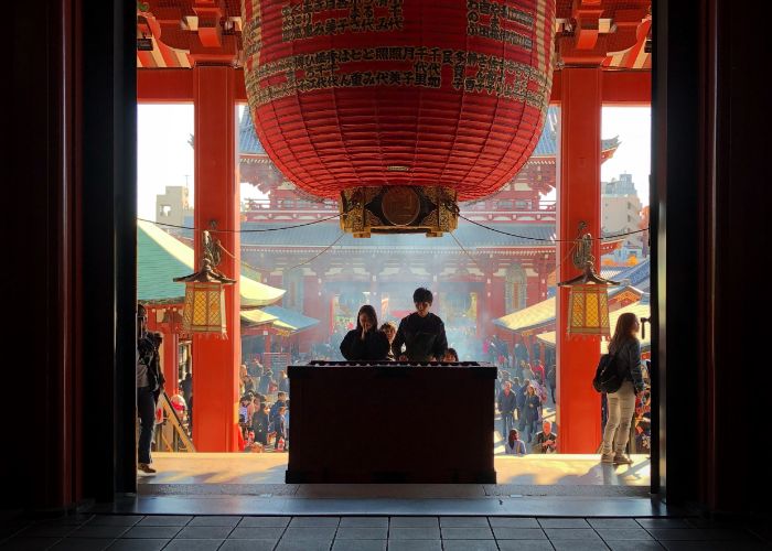 A couple praying at Senso-ji Temple in Asakusa, Tokyo