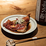 Elegant Japanese dish with sake bottle on wooden table
