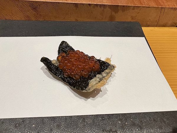 Gourmet seaweed dish topped with roe on a minimalist platter