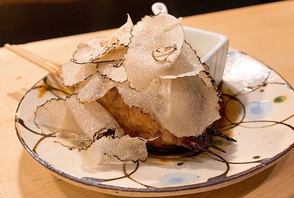 Gourmet dish with truffle shavings in an elegant restaurant setting