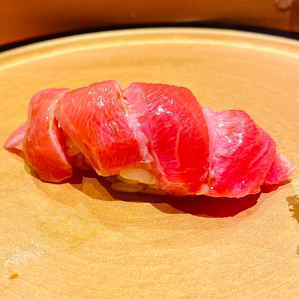 Delicious tuna sushi on a wooden plate at a restaurant
