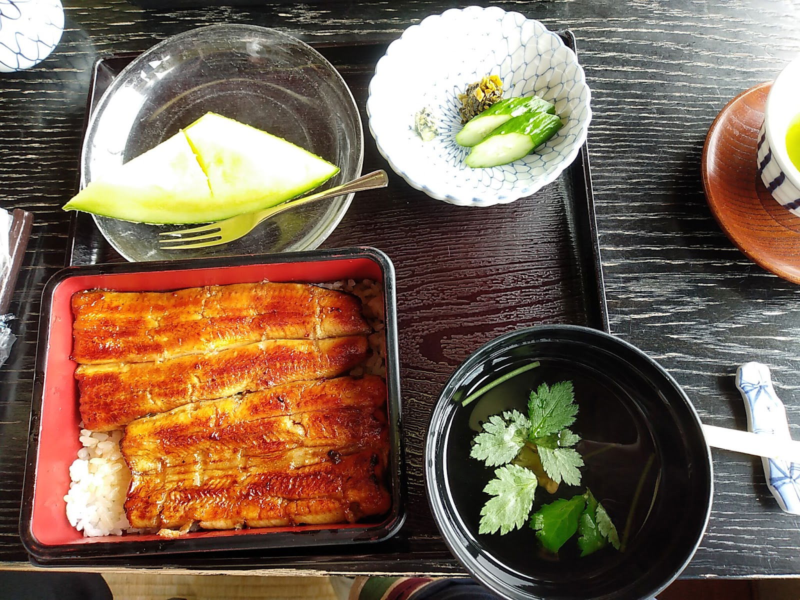 A unagi eel teishoku set meal at Unagi Komagata Maekawa Asakusa Main Branch, featuring eel over rice, pickles, soup and fruit.