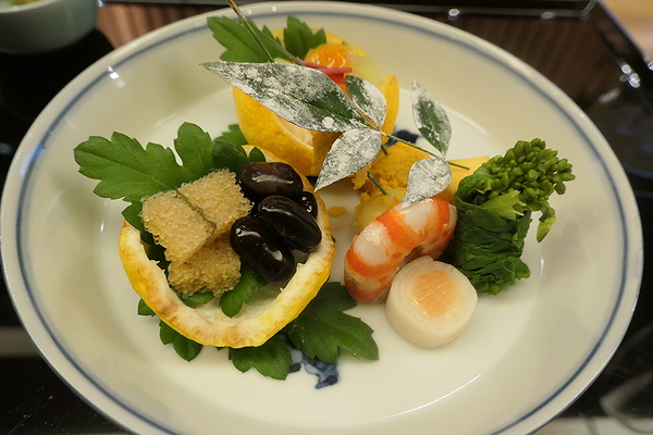 Elegant gourmet dish with shrimp, caviar, and artistic garnish