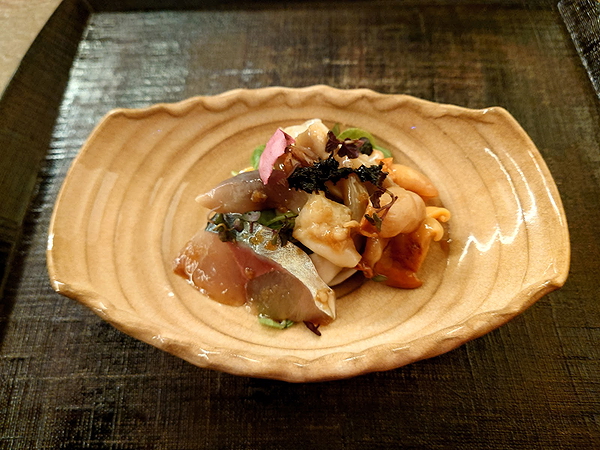 Elegant seafood dish with fresh herbs at upscale restaurant