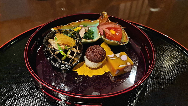 Exquisite Japanese cuisine platter on a decorative tray