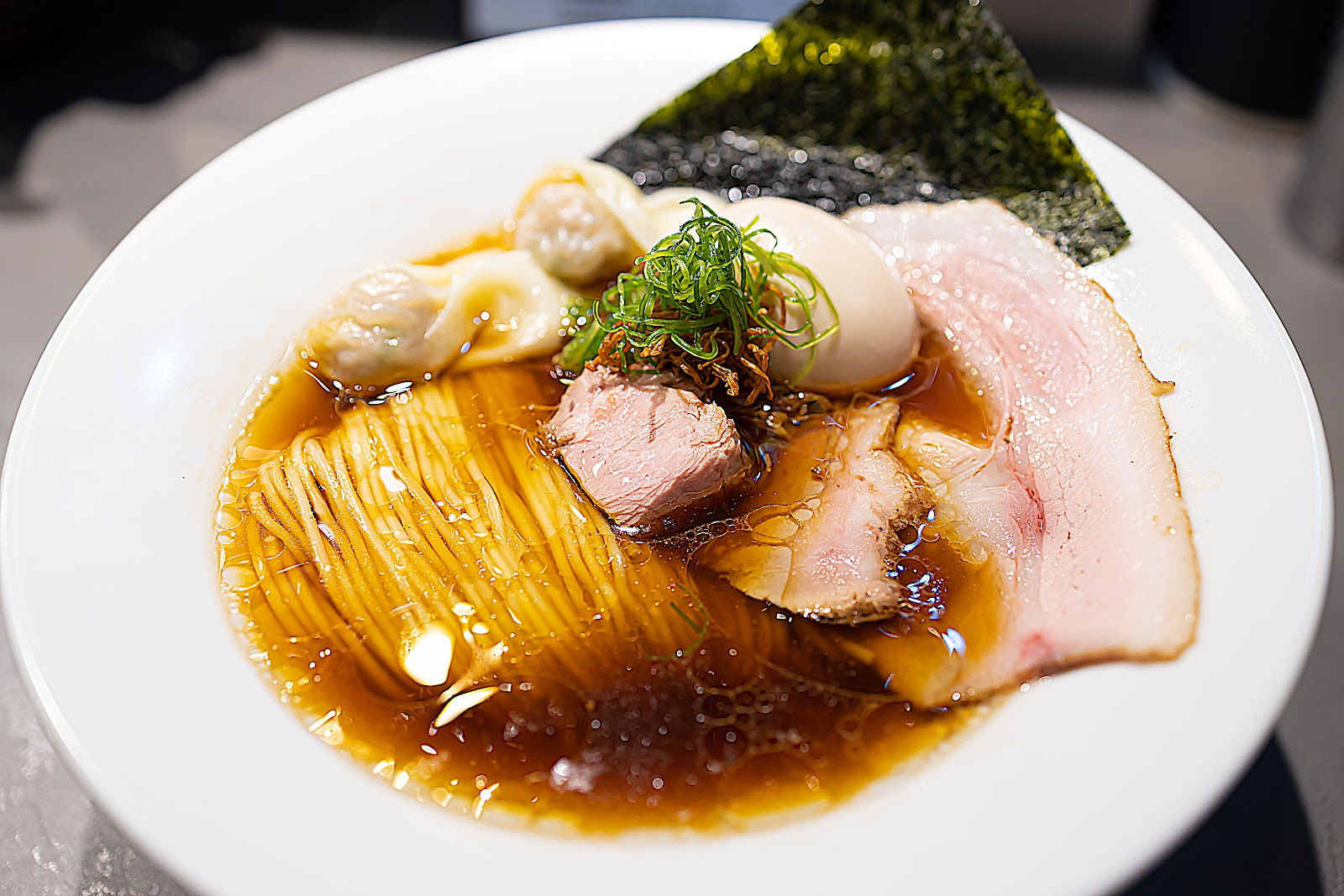 A mouthwatering bowl of ramen at Ramen Break Beats, featuring noodles, pork, egg, spring onion and seaweed.