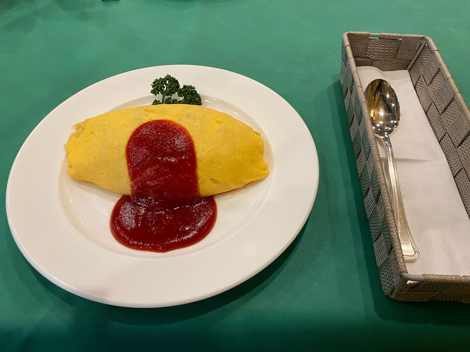 A delicious omurice plating at grill GRAND, smothered in tomato sauce.