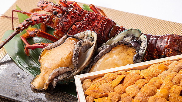 Gourmet seafood platter featuring lobster, abalone, and uni