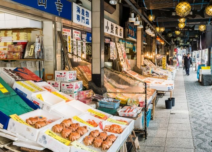 The shops and stalls of Nijo Fish Market stretch into the distance, showing off fresh seafood.