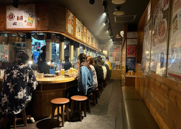 An interior shot of Daruma Jingisukan 4-4 Nikaitei, showing people lined up at the counter.