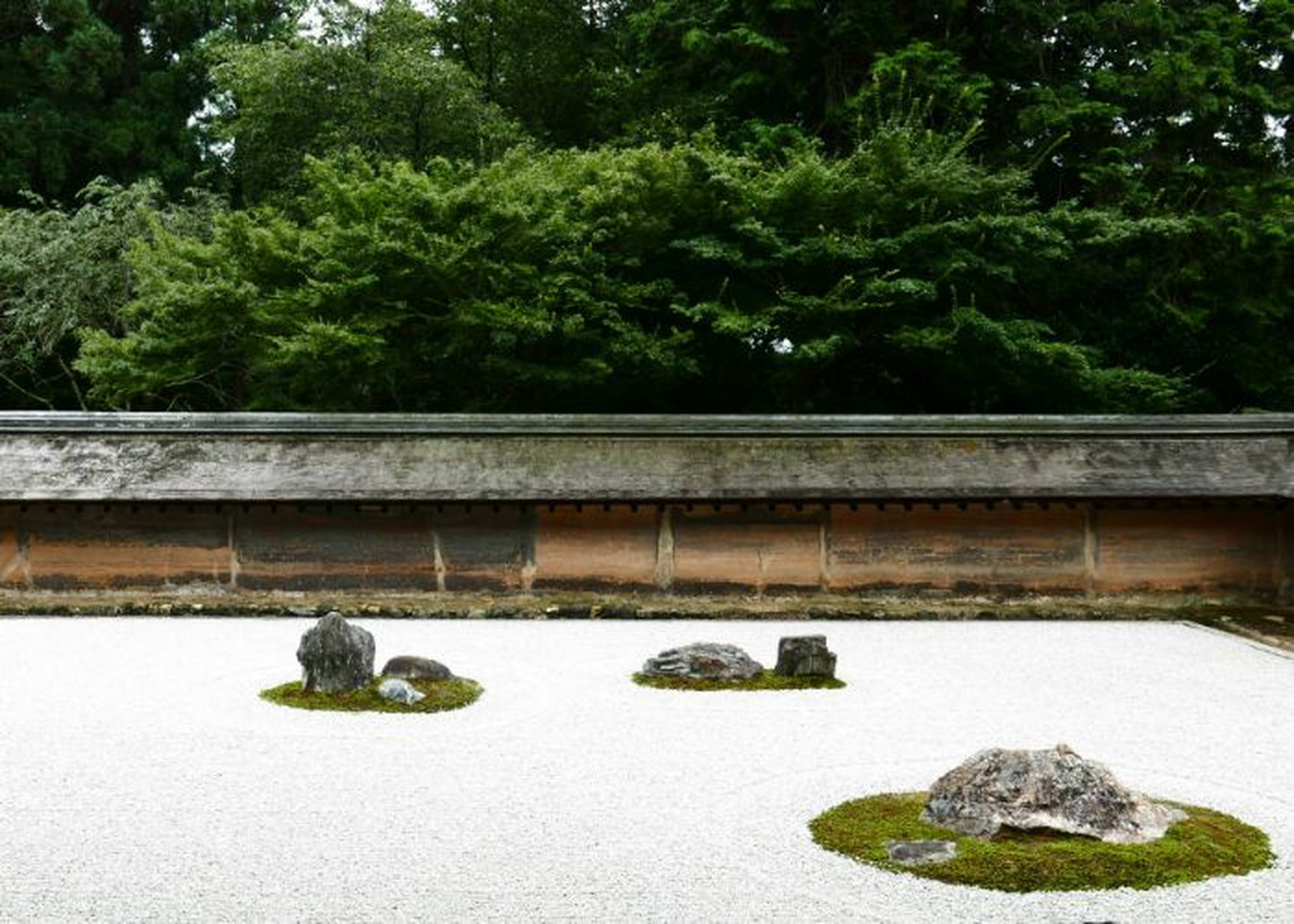 Ryoanji's Zen rock garden, with islands of rocks and moss dotted around the garden.
