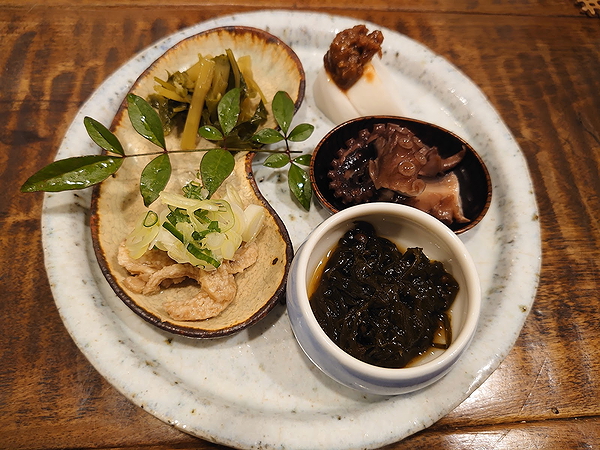 Variety of Japanese appetizers on rustic plate