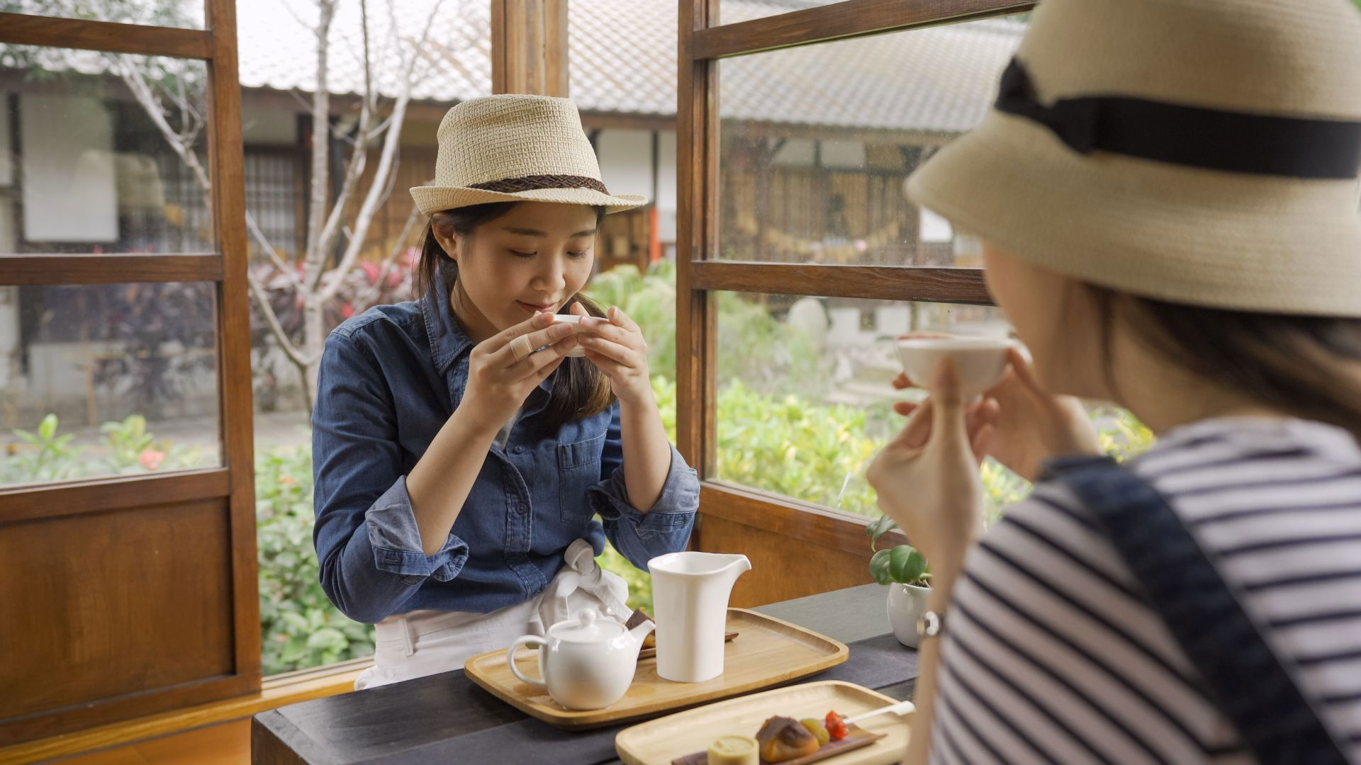 Women enjoying tea in cozy Japanese tea house