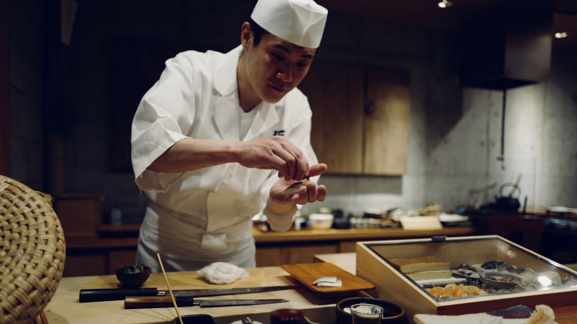 Chef preparing sushi in a traditional Japanese kitchen