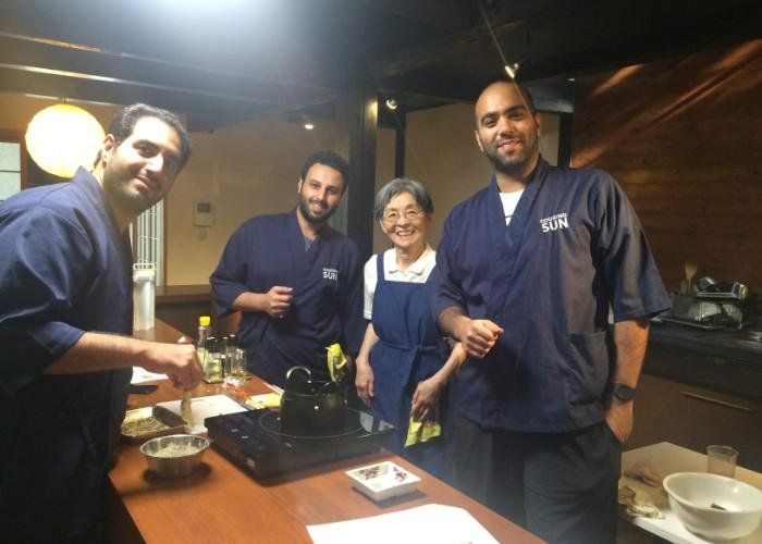 A group of people at a bento-making class, smiling at the camera.