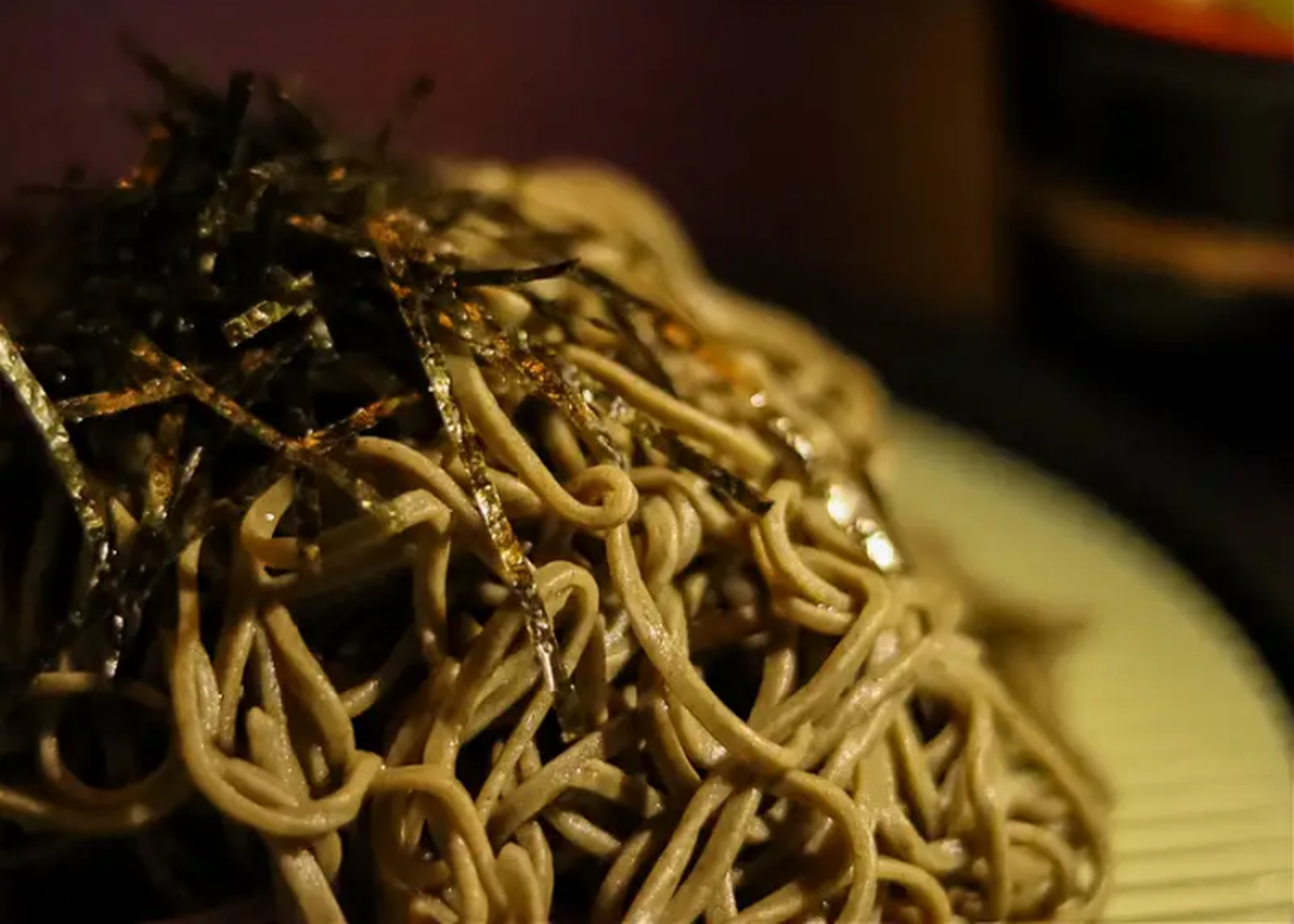 A close-up shot of cha soba on a traditional bamboo serving plate.