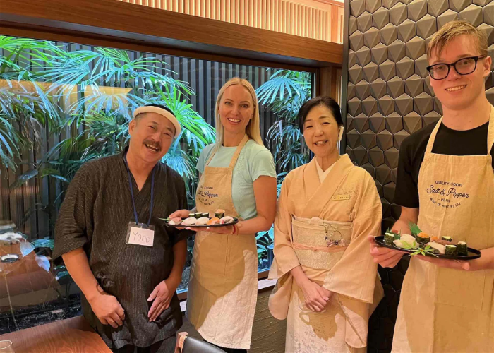 Four smiling people at a private vegan sushi cooking class in Kyoto.