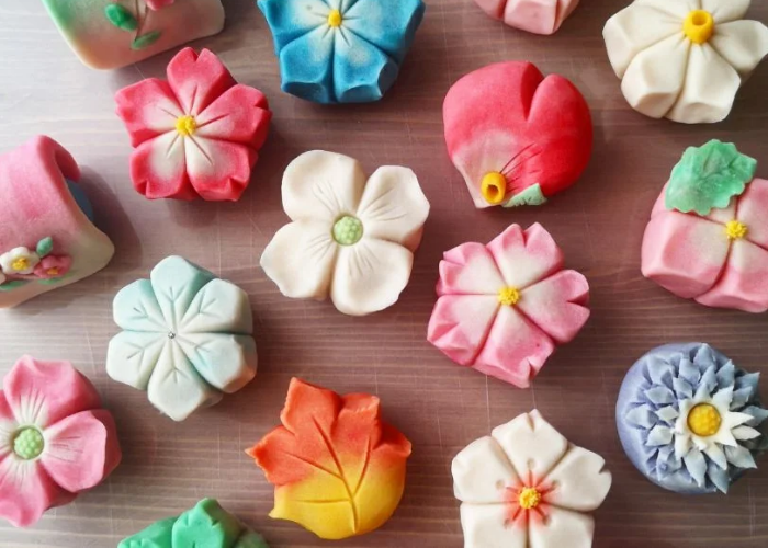 A selection of nerikiri, shaped into seasonal flowers, petals, and leaves.