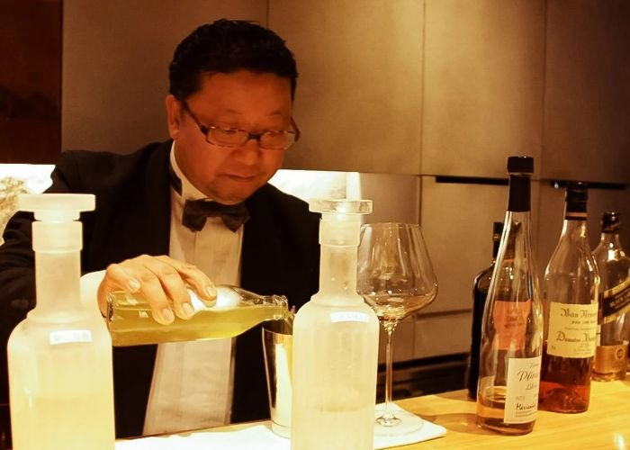 A bartender pours a cocktail in our Kyoto sake and whisky tour.
