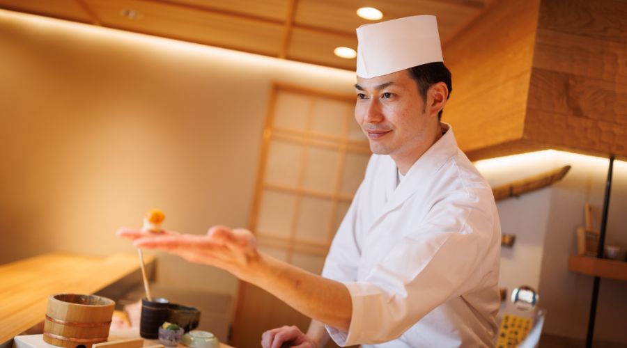 The handsome chef of Sushi Hajime handing over freshly made sushi.