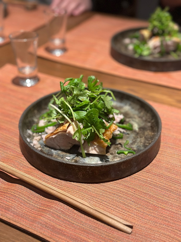 Exquisite plated dish with herbs and chopsticks in a fine dining restaurant