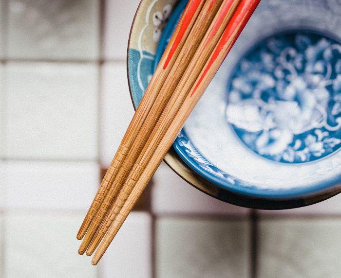 4 chopsticks on a plate