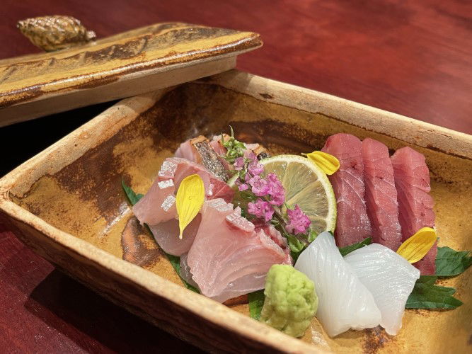 Fresh sashimi at Tozentei, garnished with edible flowers.