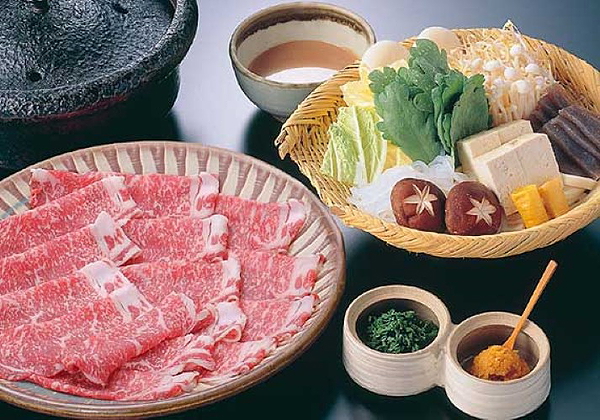 Japanese shabu-shabu spread with fresh ingredients on a restaurant table