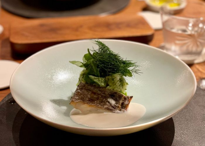 A dish at Cenci, the Michelin star Italian restaurant in Kyoto. Meat in garnished with herbs.