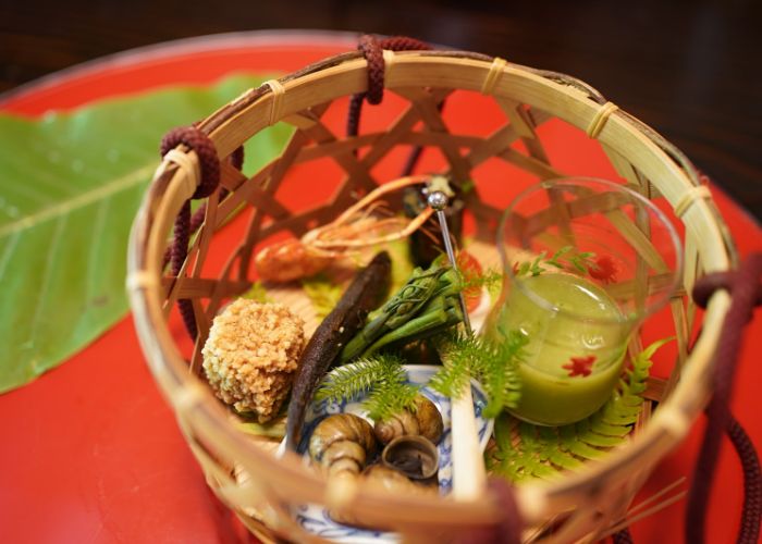 A dish served in a bamboo basket at Miyamasou, an eco-friendly Michelin star restaurant in the mountains of Kyoto.
