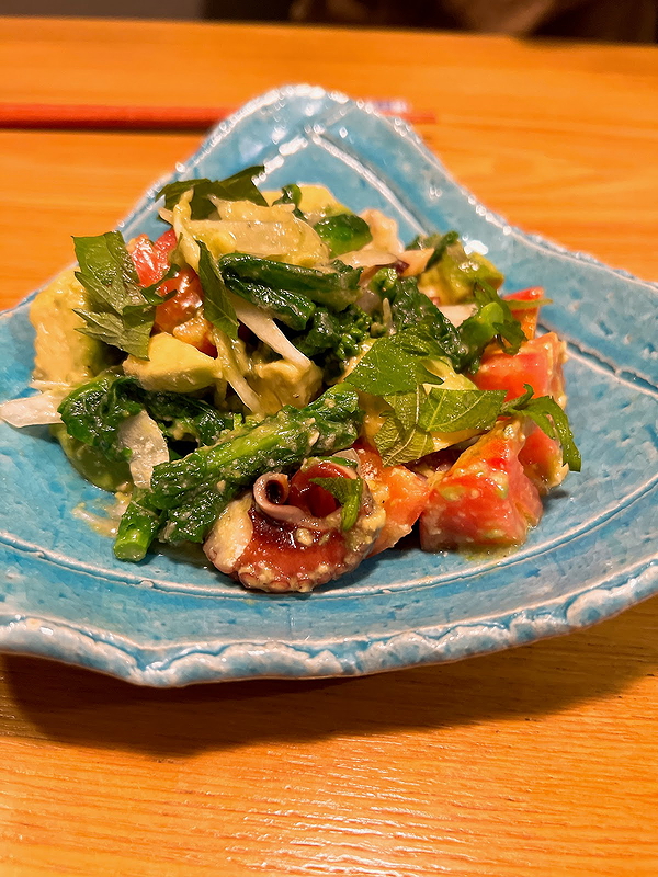 Colorful seafood salad on a blue ceramic plate at fine dining restaurant