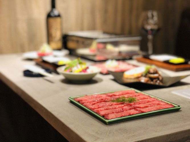 A feast laid out on a table at Yakiniku Kokonomi.