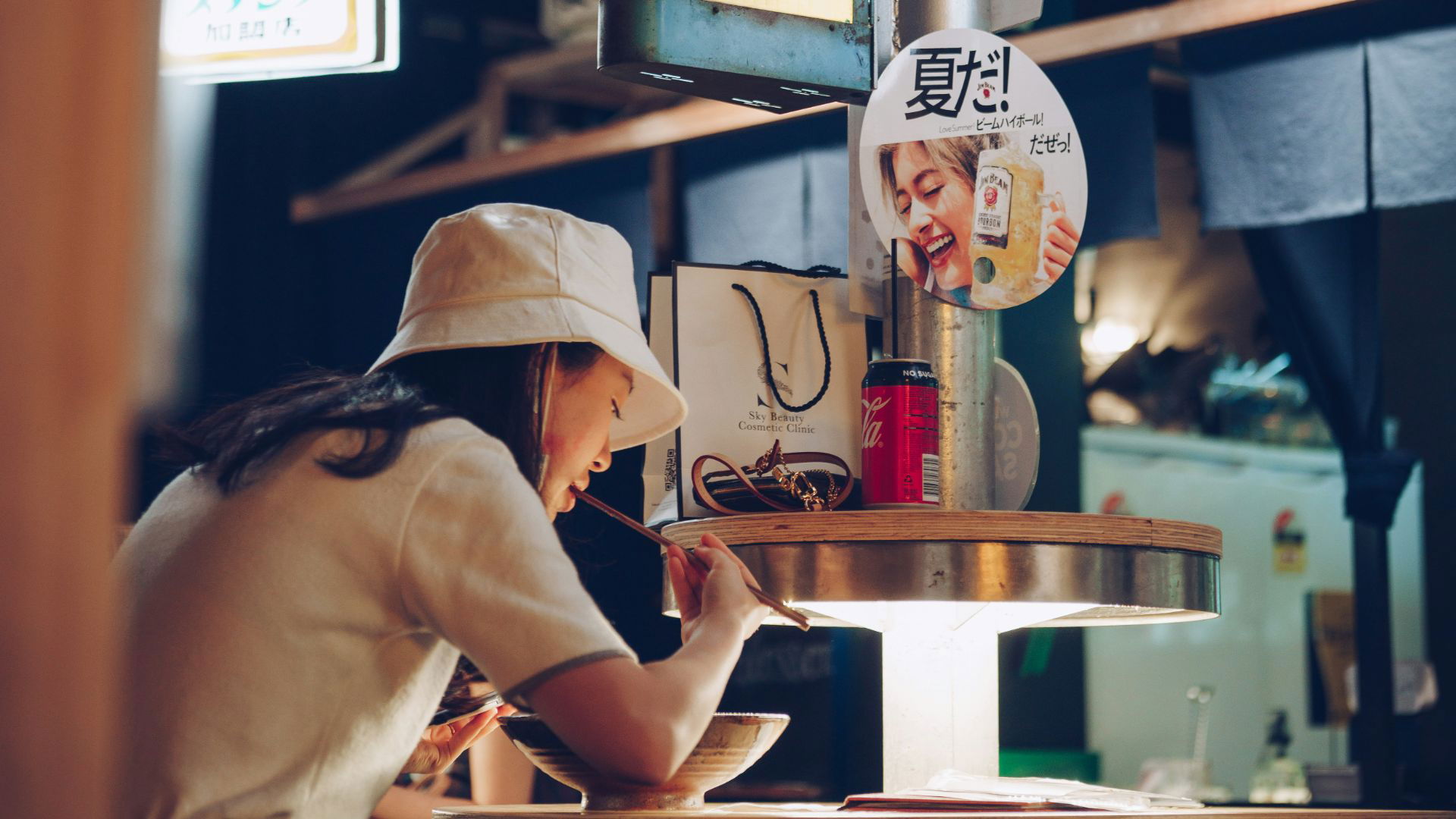 Woman enjoying ramen in a cozy Japanese restaurant