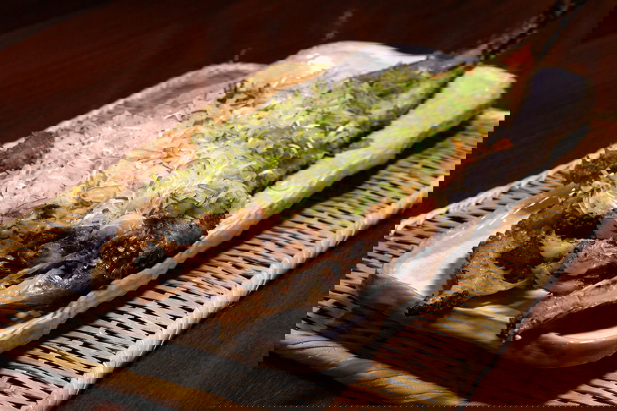 A fileted and grilled fish topped with spring onion at Robata Omoto Kagurazaka.