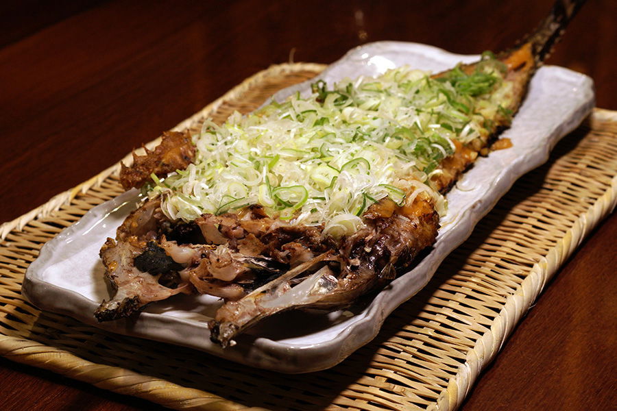 A fileted and grilled fish topped with spring onion at Robata Omoto Kagurazaka.