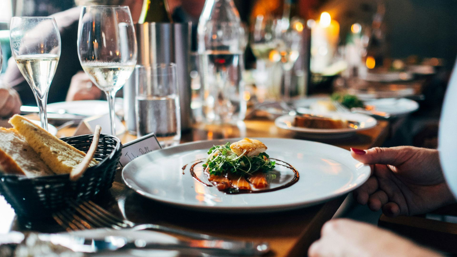 Elegant dining setup with gourmet dish and wine glasses