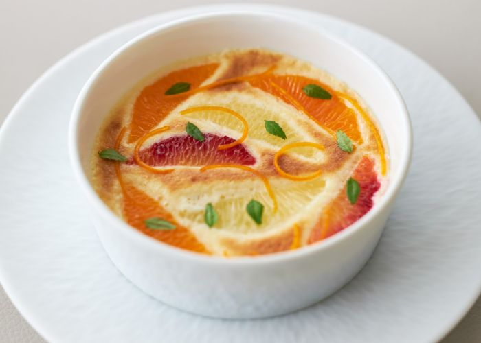 A beautifully decorated, orange dish at Sezanne, #1 on Asia's 50 Best Restaurants 2024.