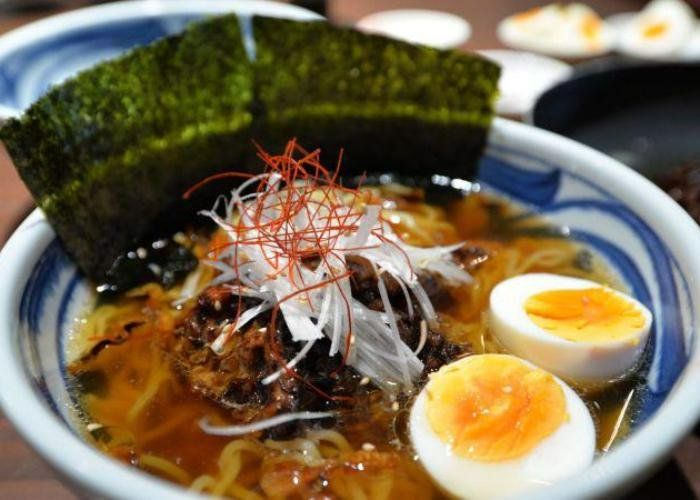 A close-up shot of ramen made at a ramen cooking class, featuring noodles, seaweed, and a boiled egg.