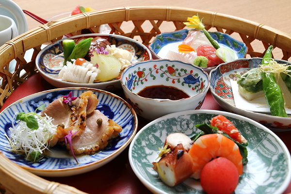 Assorted Japanese dishes in a traditional basket display