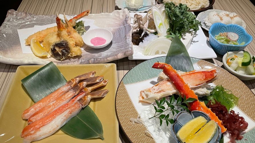 Exquisite Japanese seafood course featuring crab legs and tempura