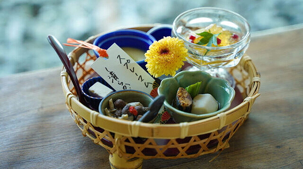 Elegant Japanese dish with flowers and intricate appetizers