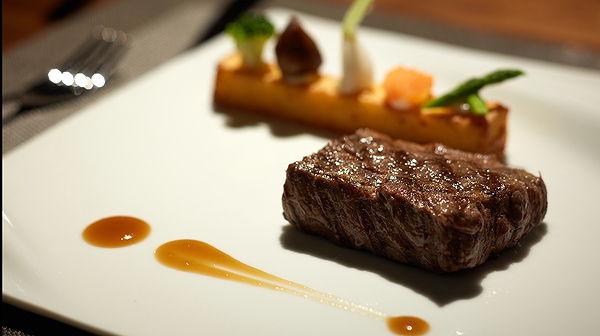 Gourmet steak dish with elegant plating at a fine dining restaurant