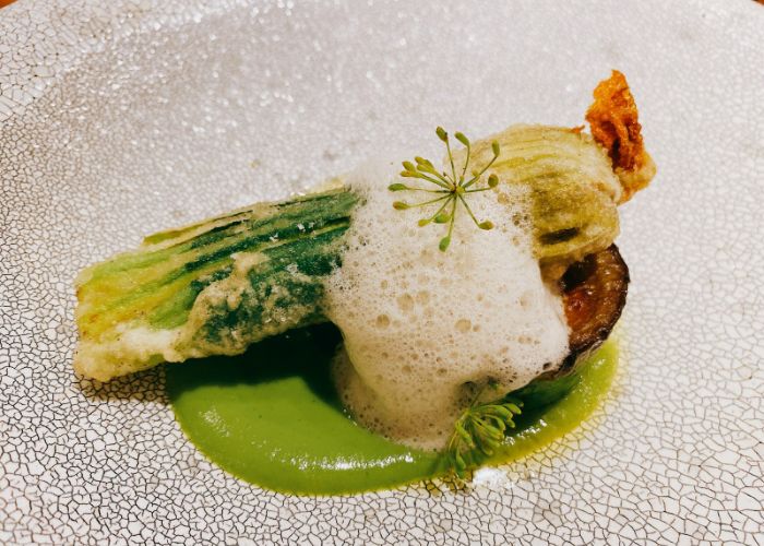 A Michelin star vegan dish at Noeud.Tokyo, showing different textures and shades of natural green.