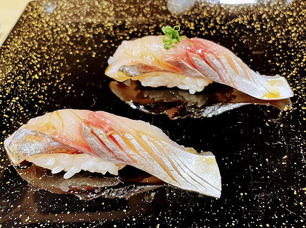 Elegant sushi nigiri on black speckled plate